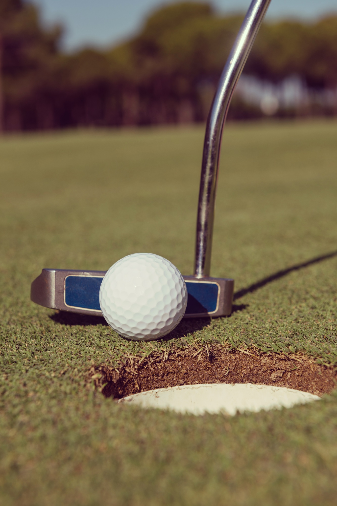 hitting golf ball to hole